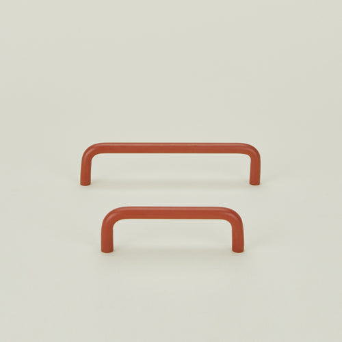 Small and large drawer pulls in Terracotta.