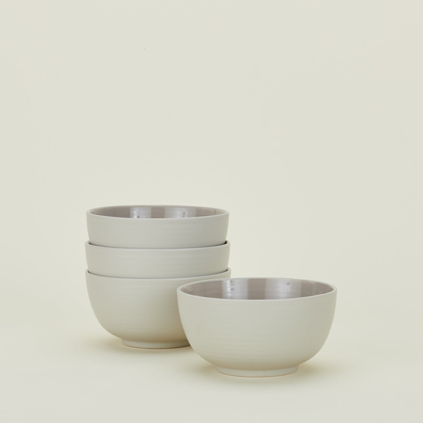 Four light grey Essential Large Bowls.