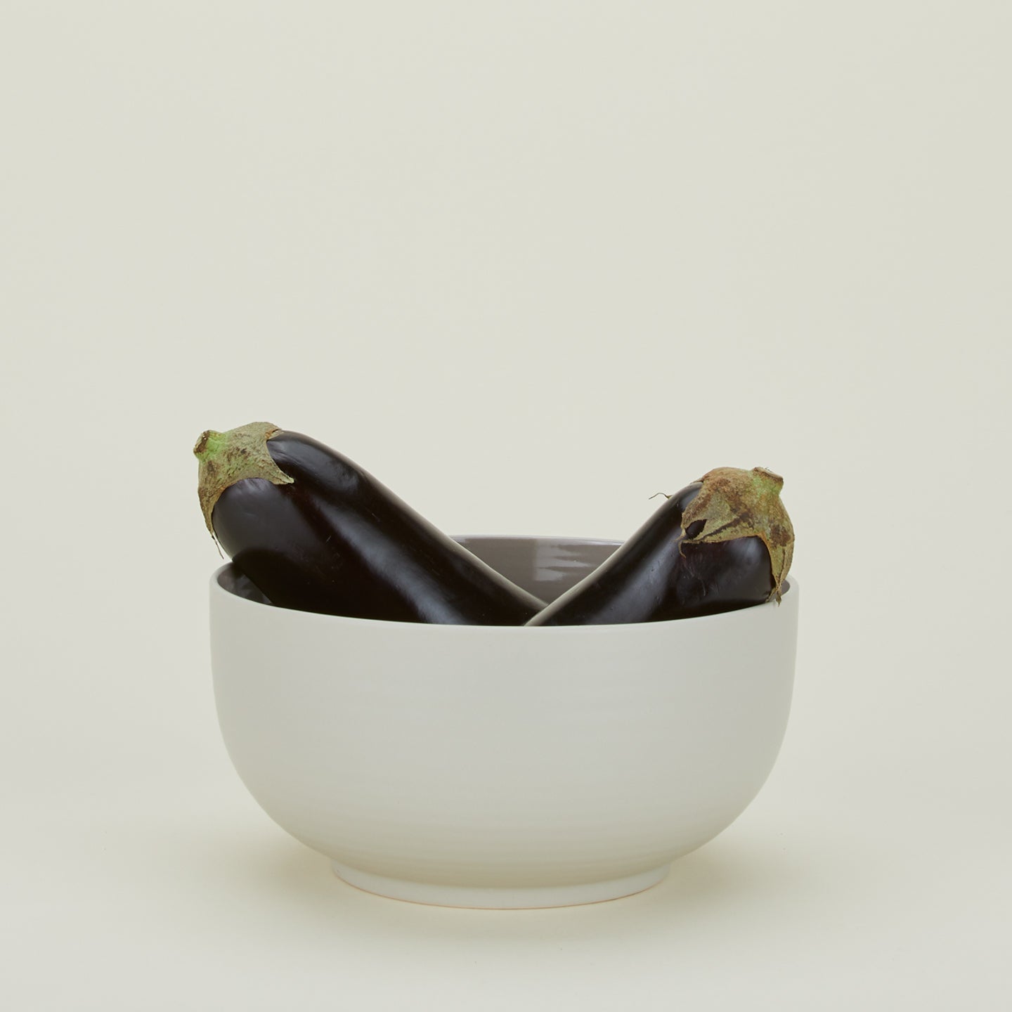 Essential Serving Bowl in Light Grey with eggplant.