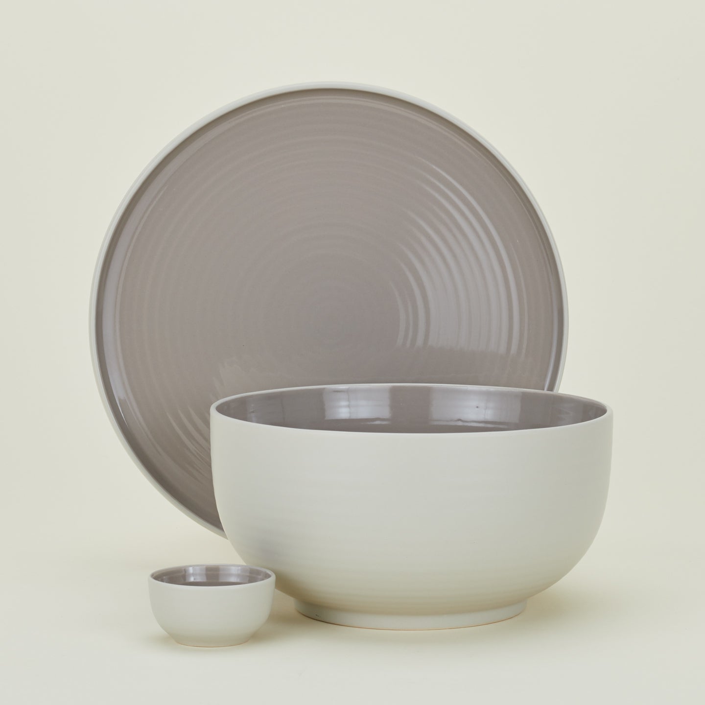 Group of Essential serving pieces in Light Grey including bowl, platter and extra small bowl.