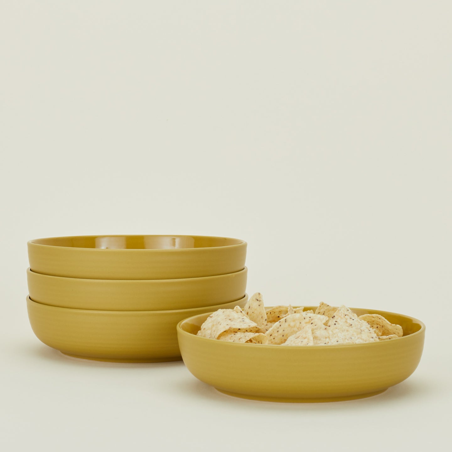 Four Essential Low Bowls in Mustard, with tortilla chips.