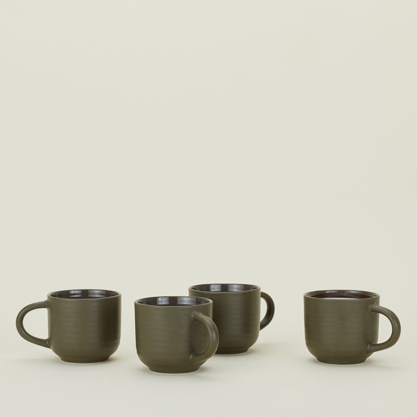 Four Essential Mugs in Olive, with coffee.