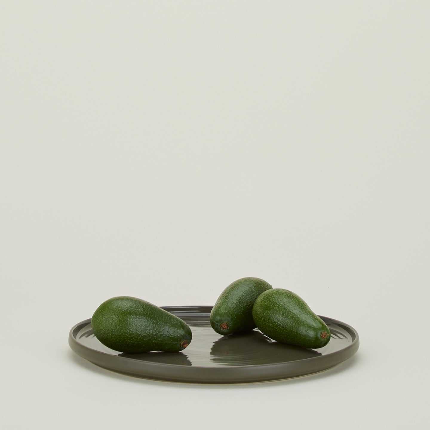 Essential Serving Platter in Olive with avocados.