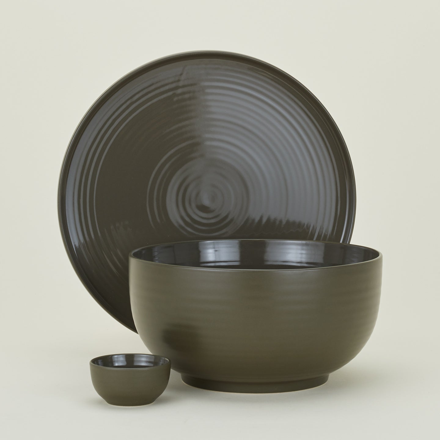 Group of Essential serving pieces in Olive including bowl, platter and extra small bowl.