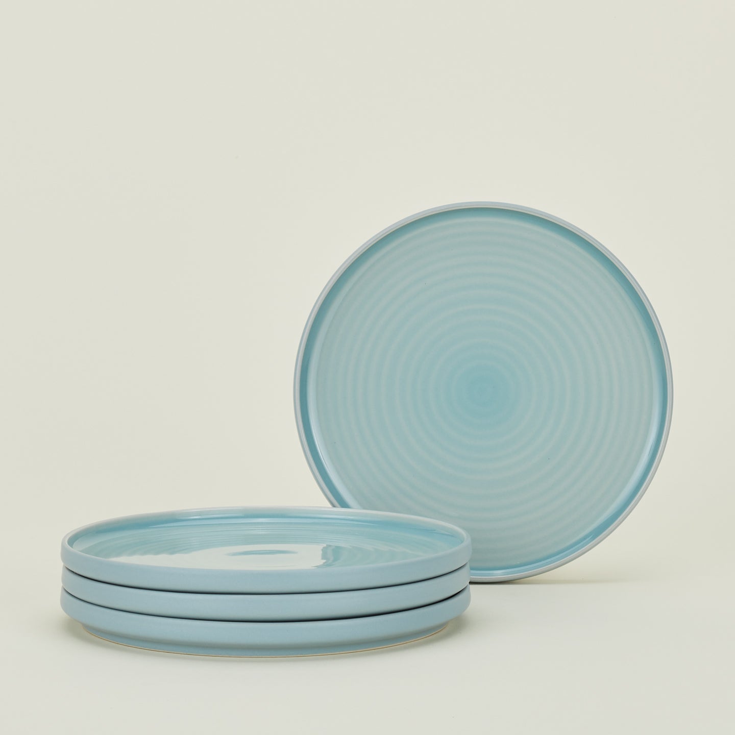 Four sky blue Essential Salad Plates.