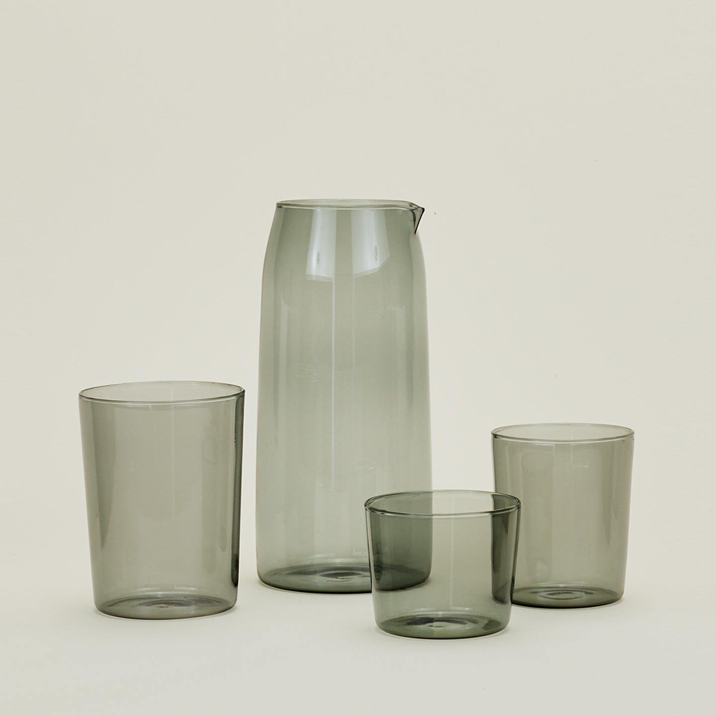 Small, Medium and Large Essential Glasses with Essential Glassware Pitcher in Smoke.
