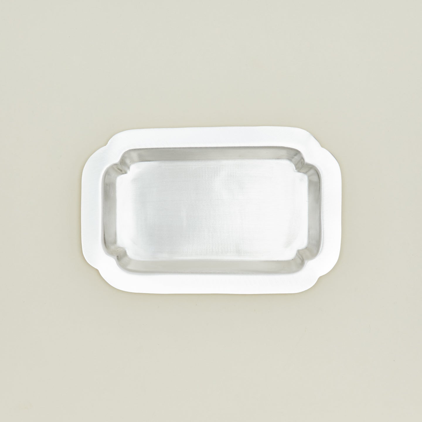 Overhead view of decorative edge rectangular silver tray