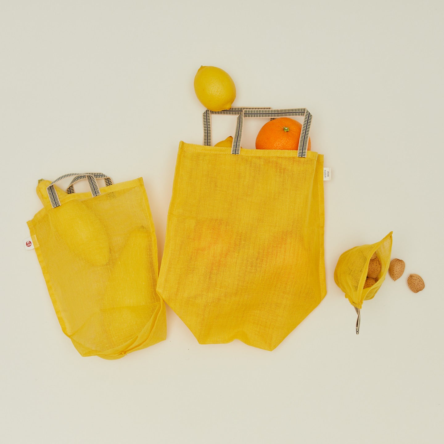 Fort + Field eco produce bags in yellow with various fruits and walnuts