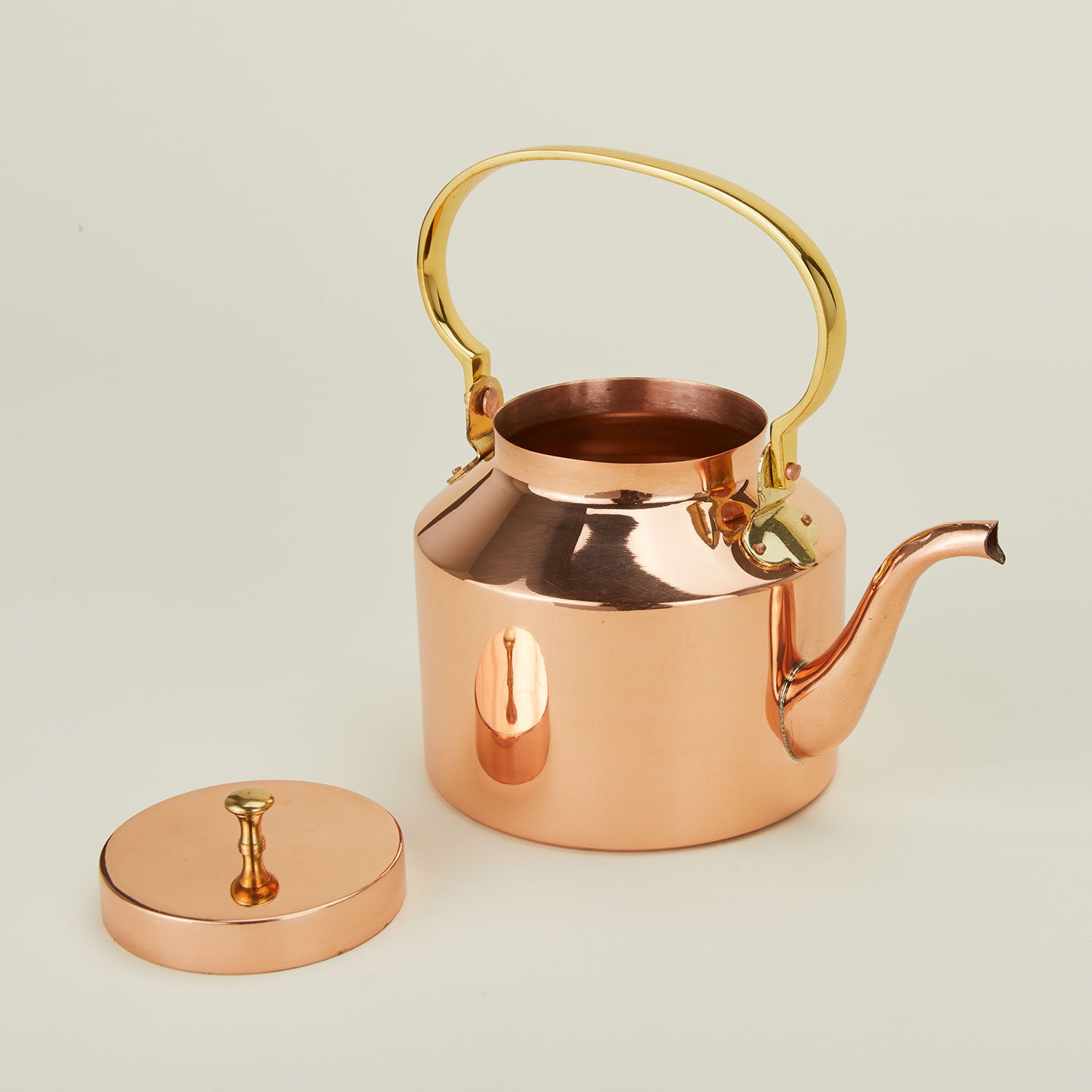 Close up of English copper tea kettle with brass handle.