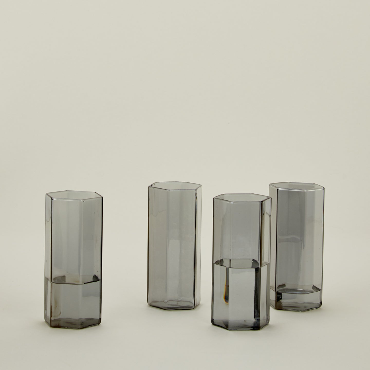 Set of 4 large Helix Glasses in Grey with water.