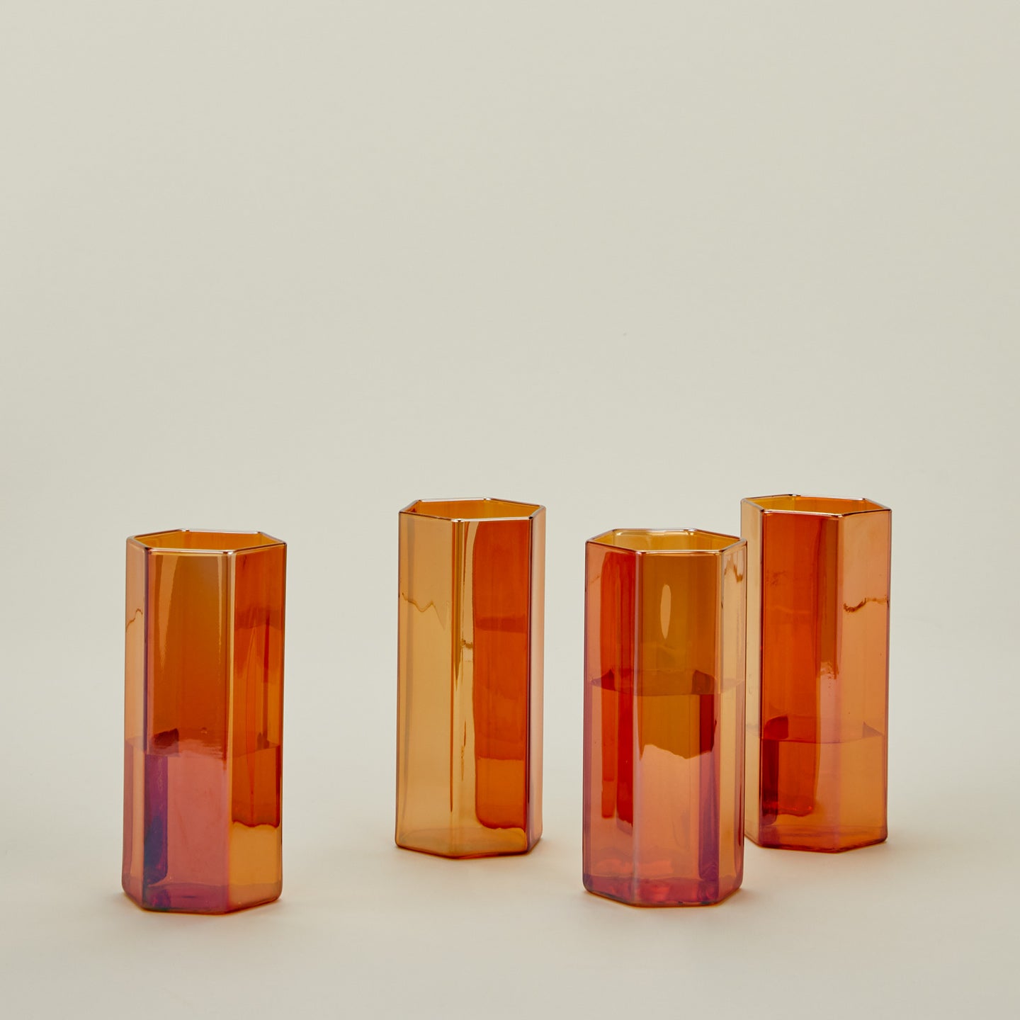 Set of 4 large Helix Glasses in Orange with water.