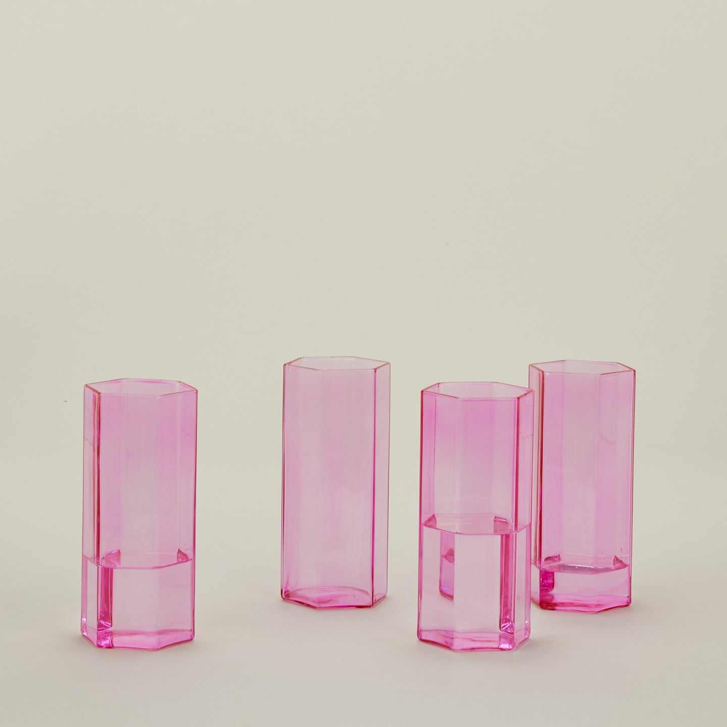 Set of 4 large Helix Glasses in Pink with water.