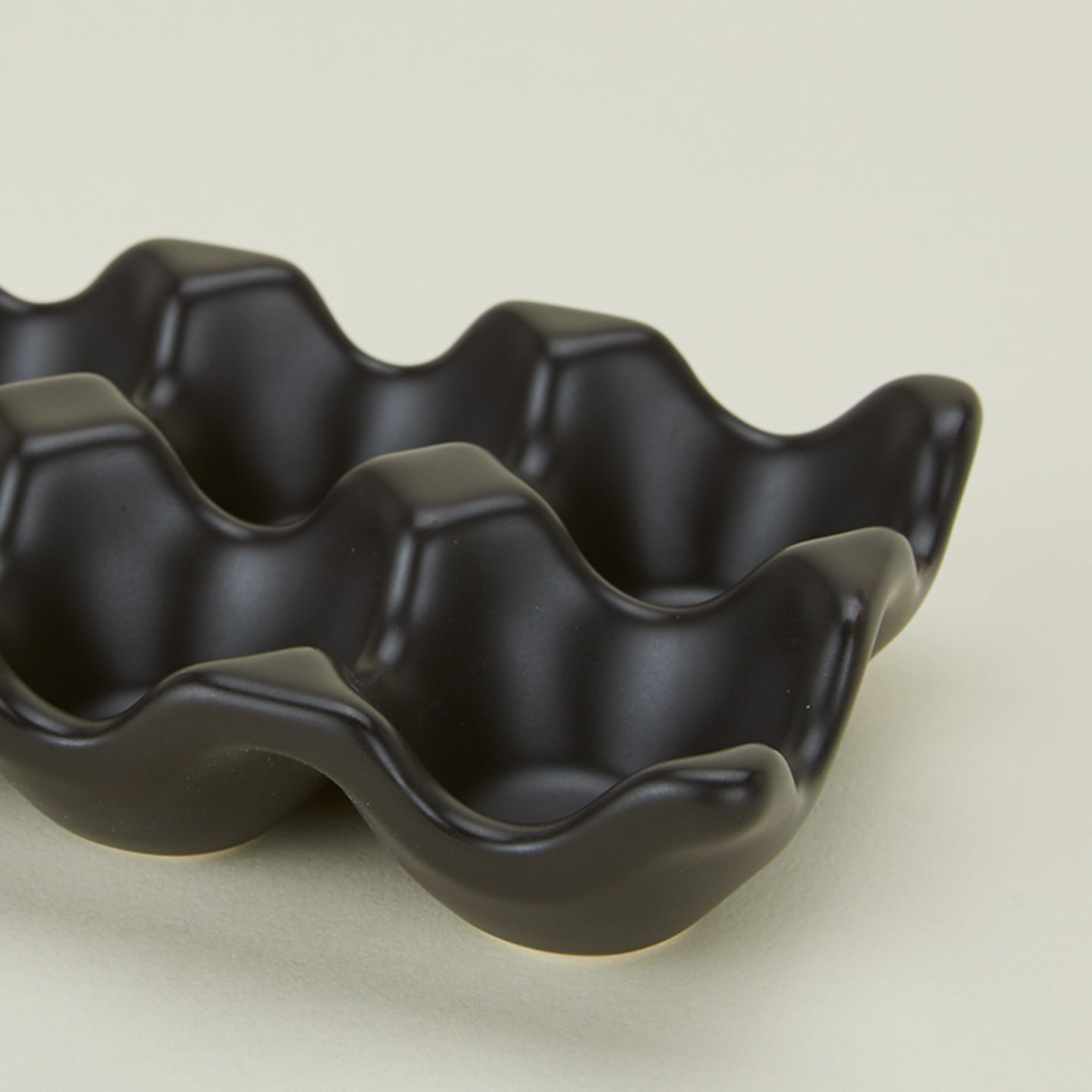 Detail view of ceramic half dozen egg holder in black