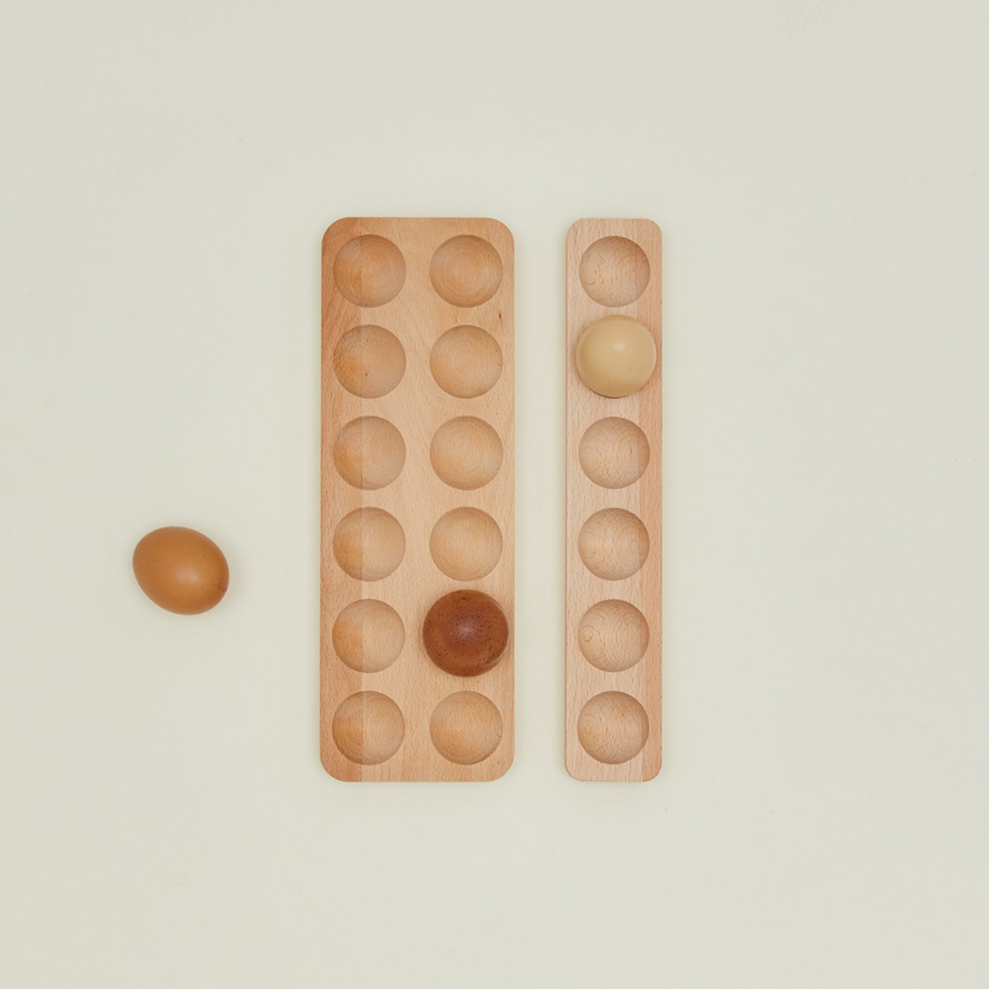 Overhead view of wooden egg holder family