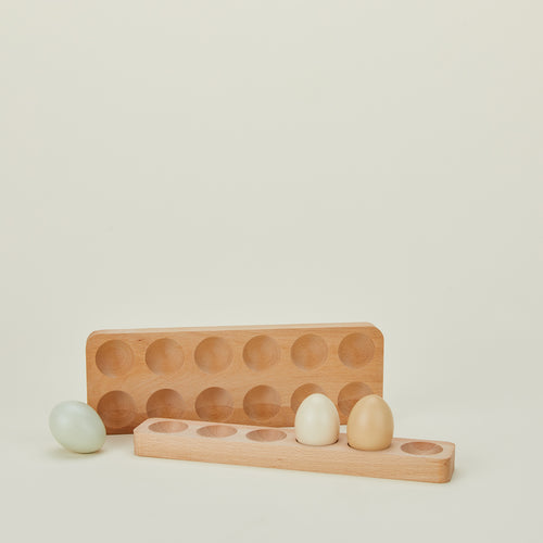 Wooden egg holder family with eggs