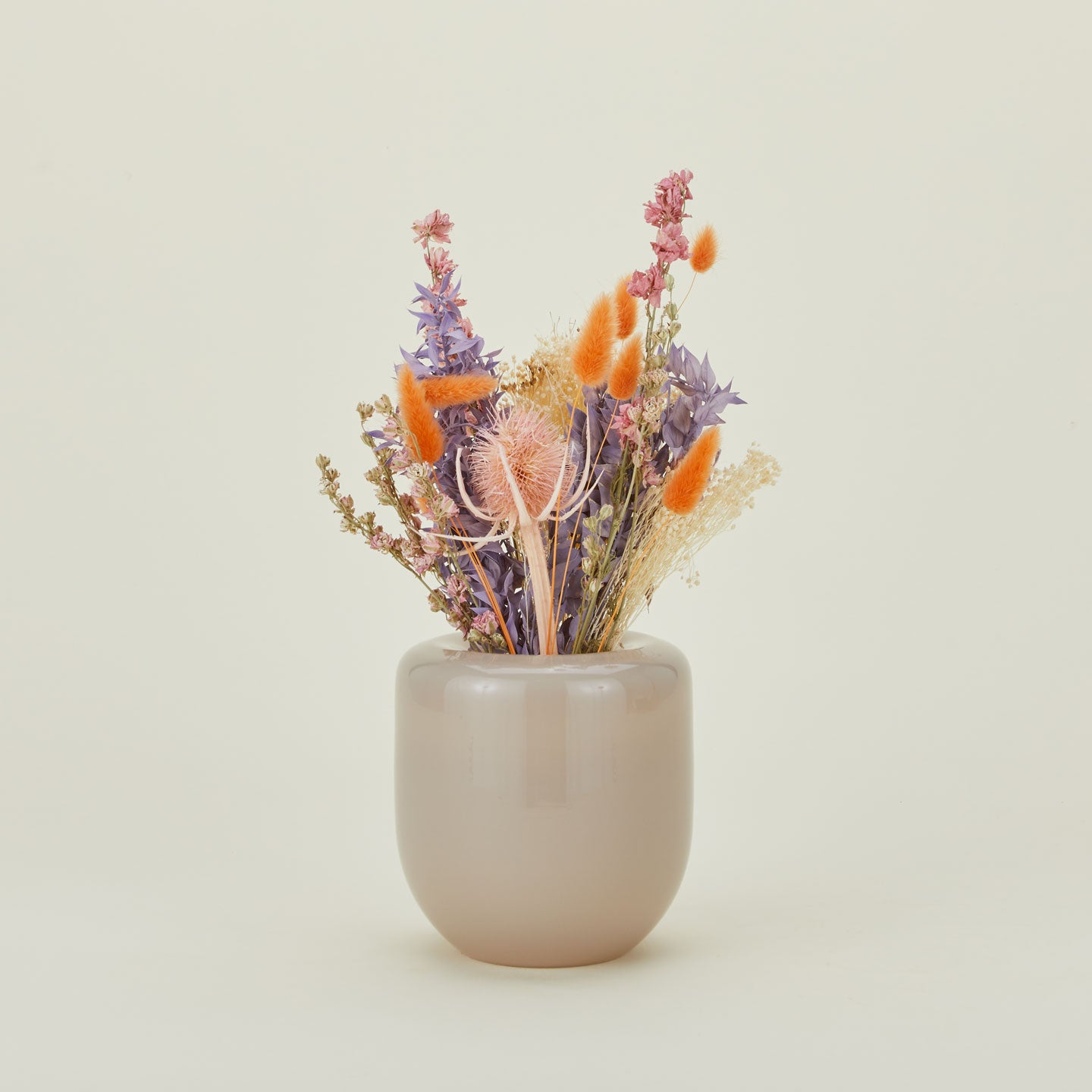 Dried floral bouquet in bright colors in a vase.