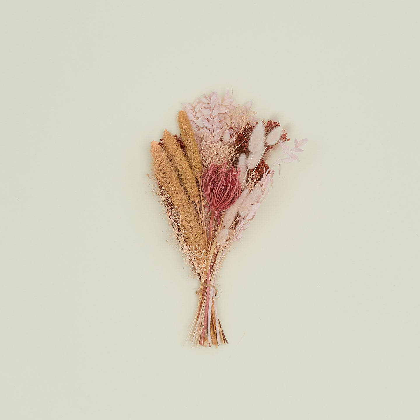 Dried floral bouquet in pink and coral.