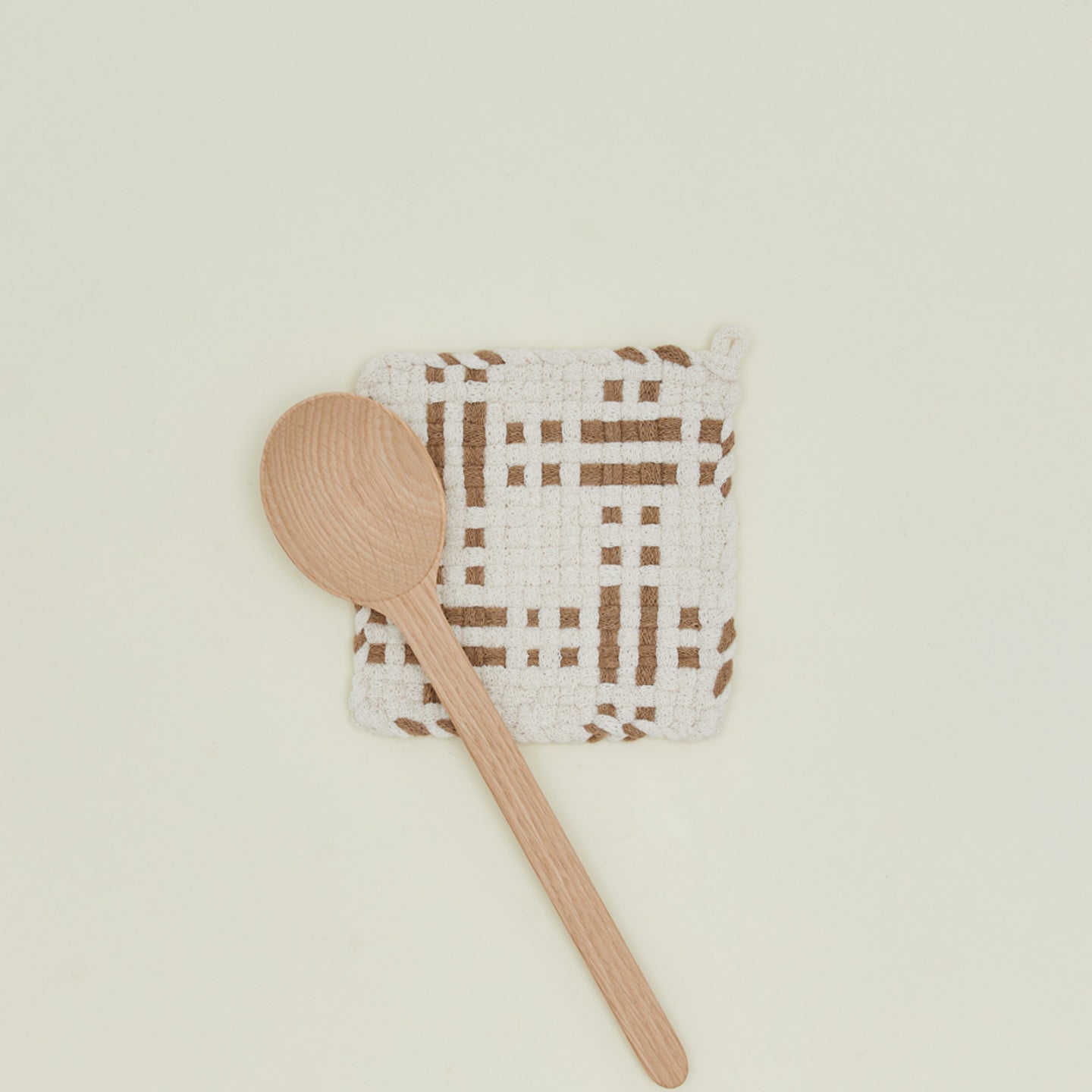 Dots and dashes potholder in white and flax with wooden spoon