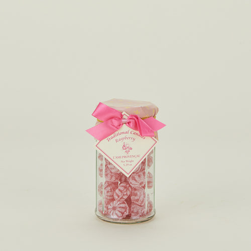 Traditional raspberry candies in glass jar with bow