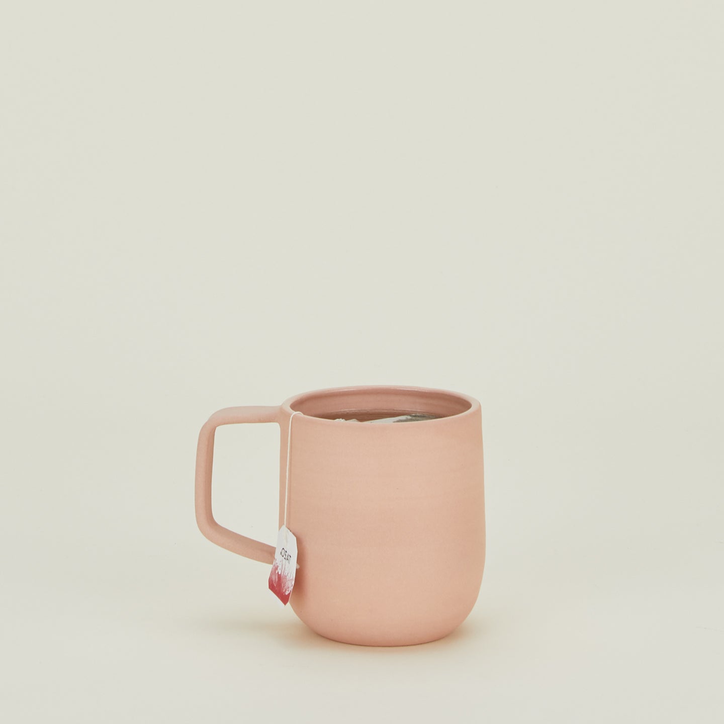 Stoneware Pigment Mug in Blush filled with tea.