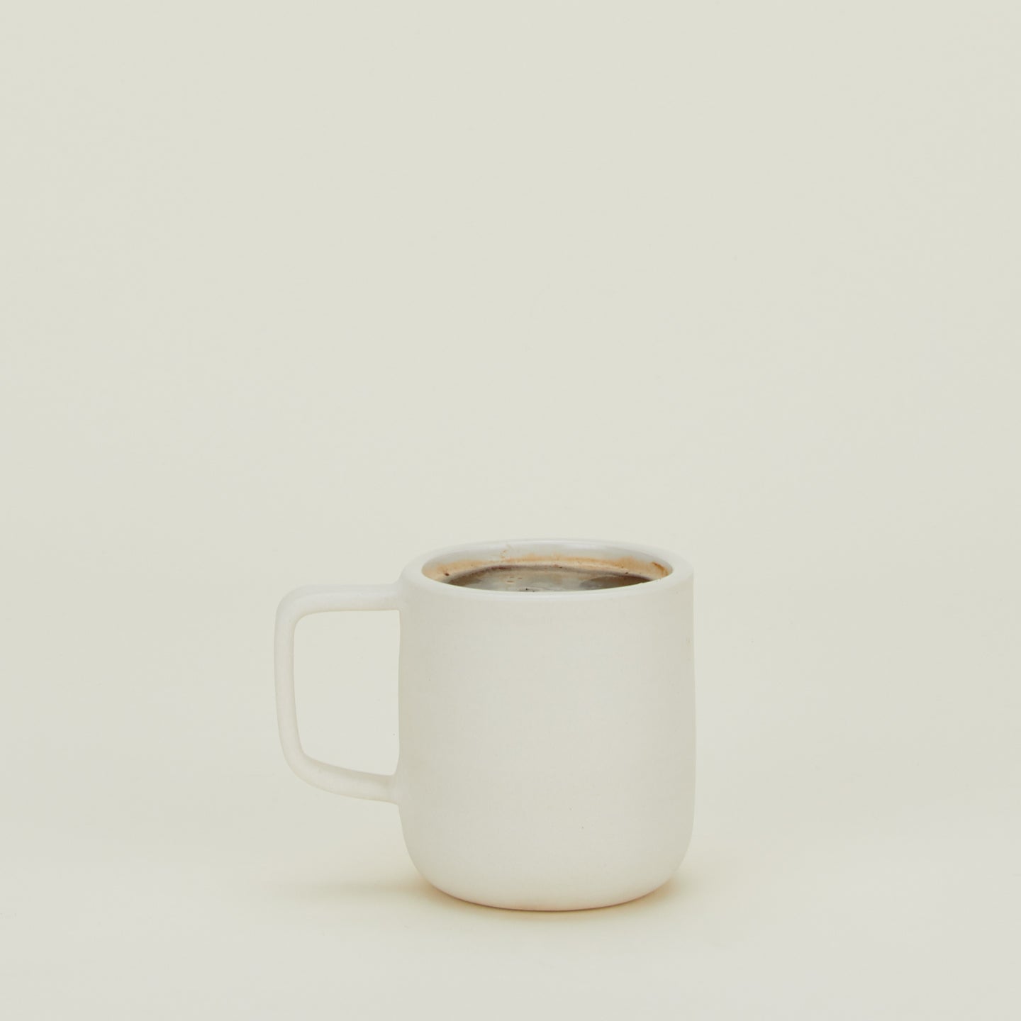 Stoneware Pigment Mug in Ivory filled with hot cocoa.