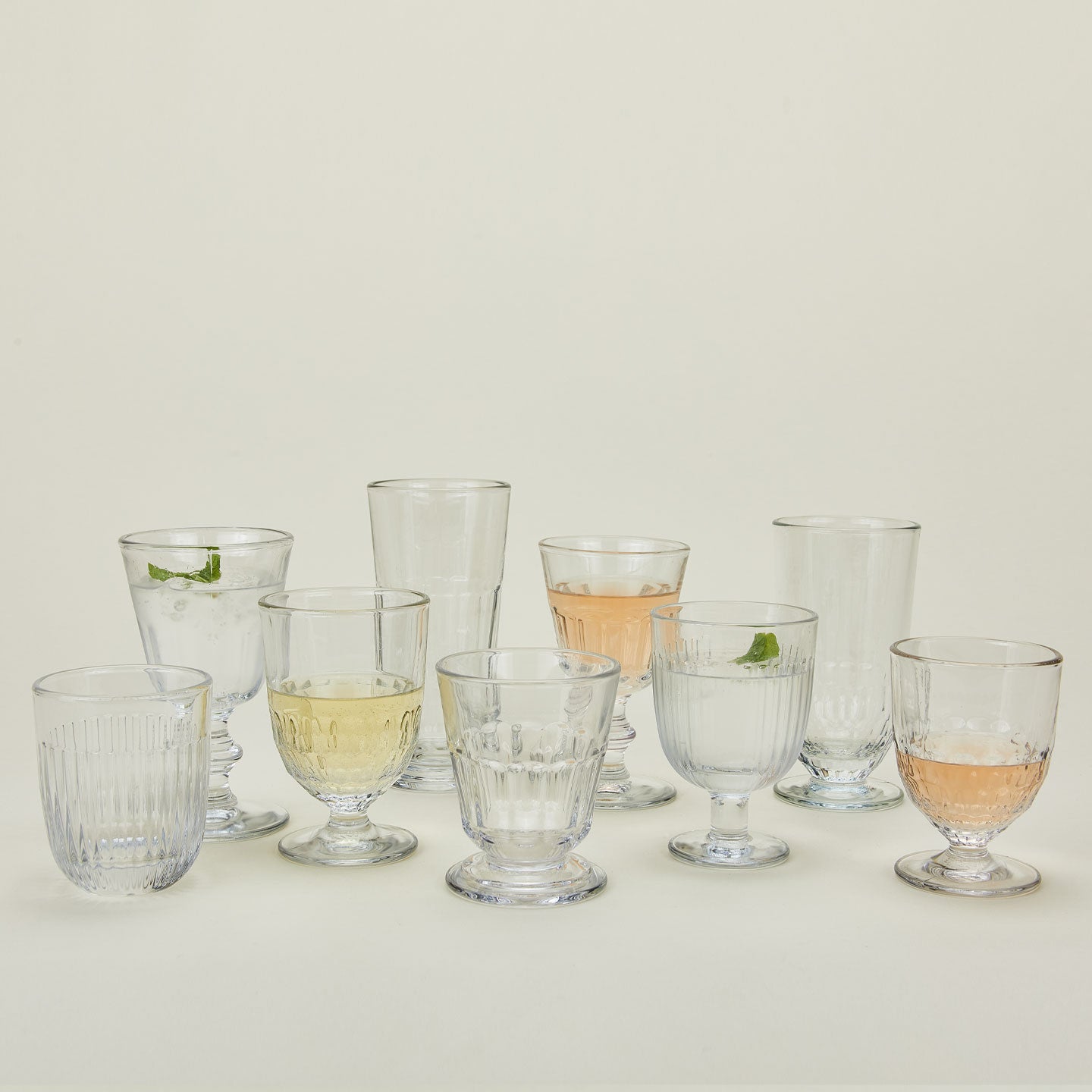 La Rochere glassware in various shapes and sizes, some with wine or water.