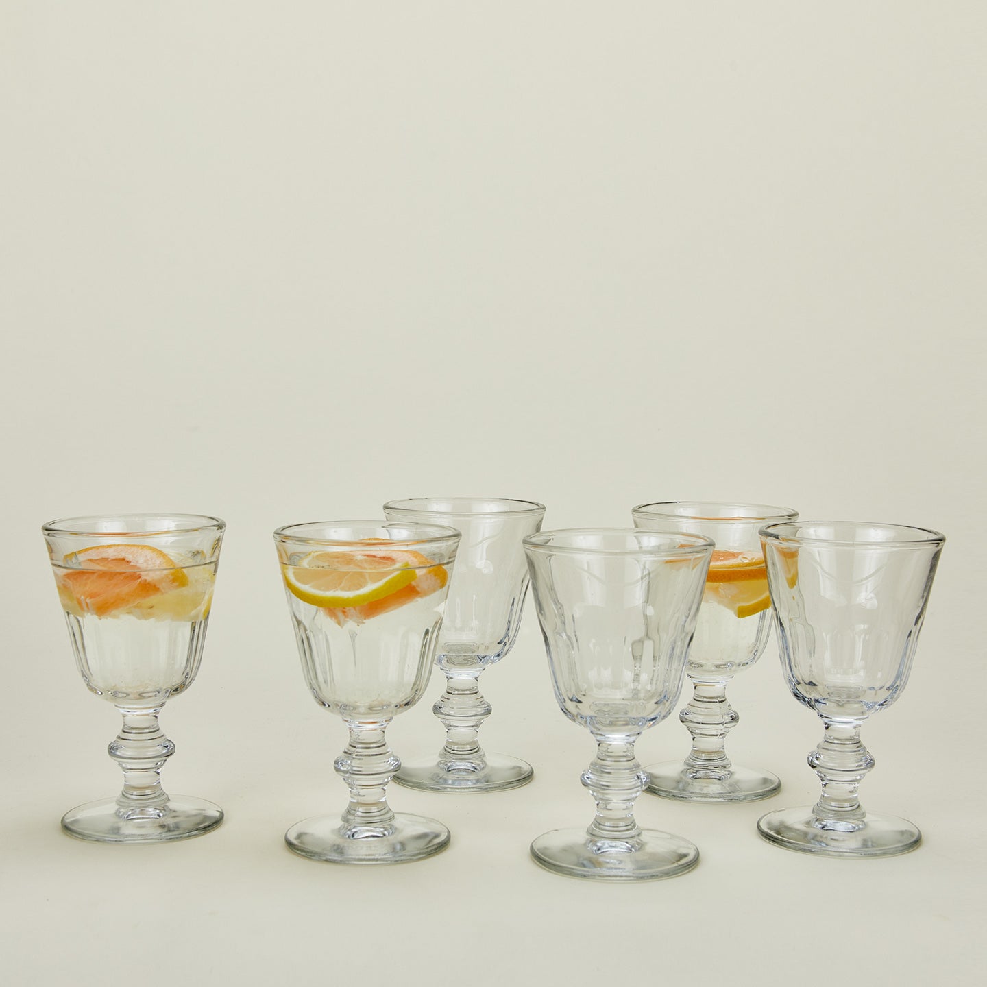 Six Perigord water glasses, some with fruit infused water.