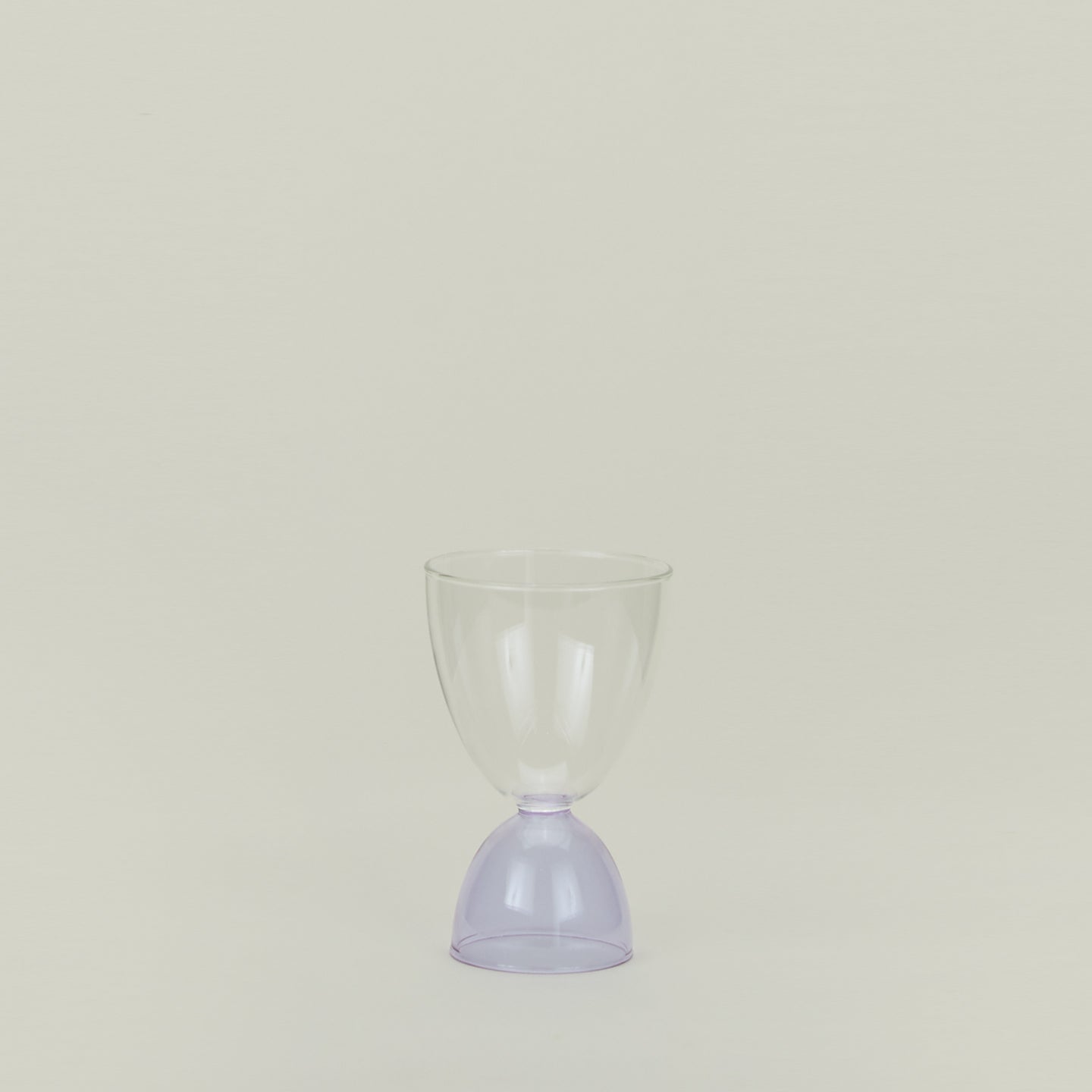 Tumbler glass with lilac stem and clear cup.