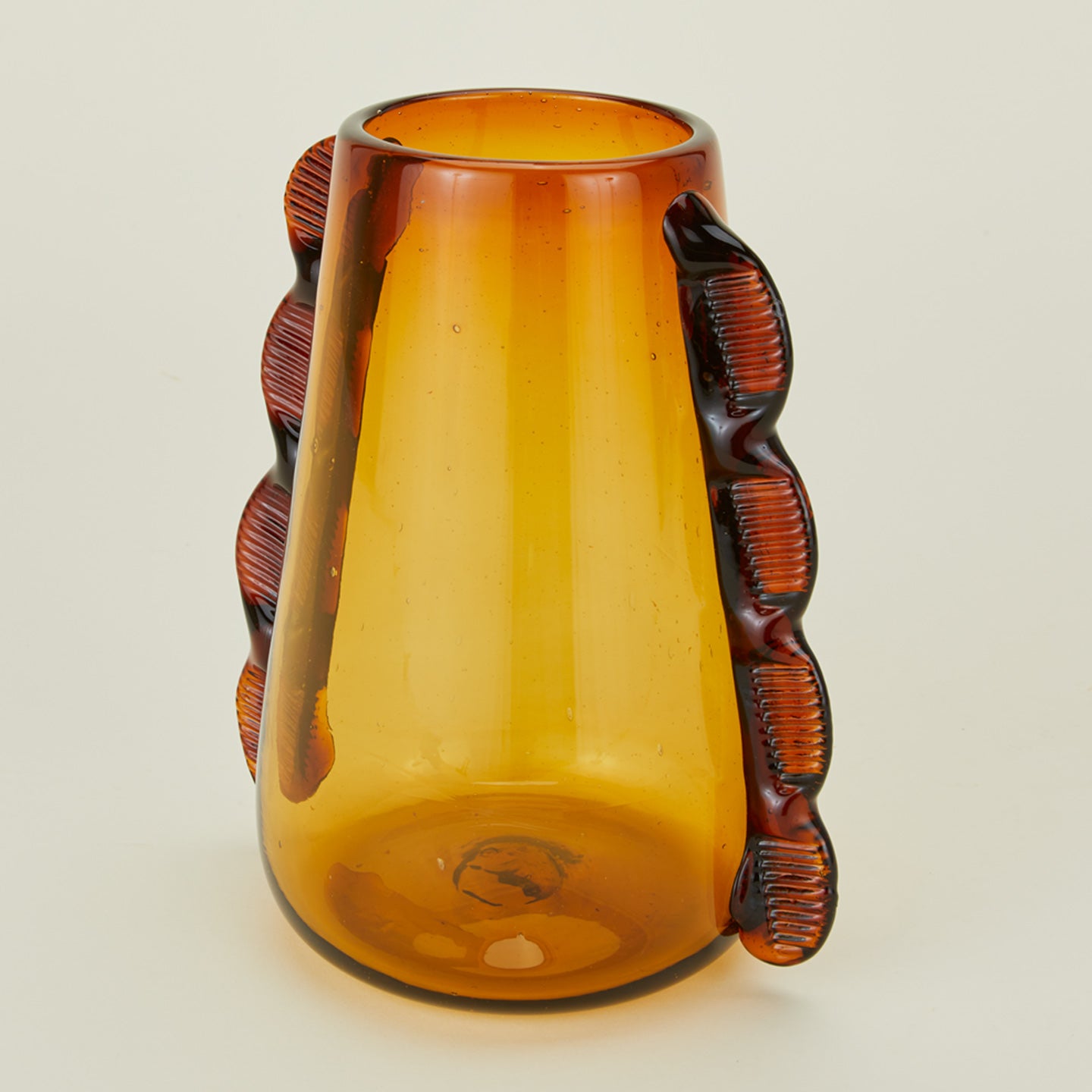 Close up of Betta glass amber vase.