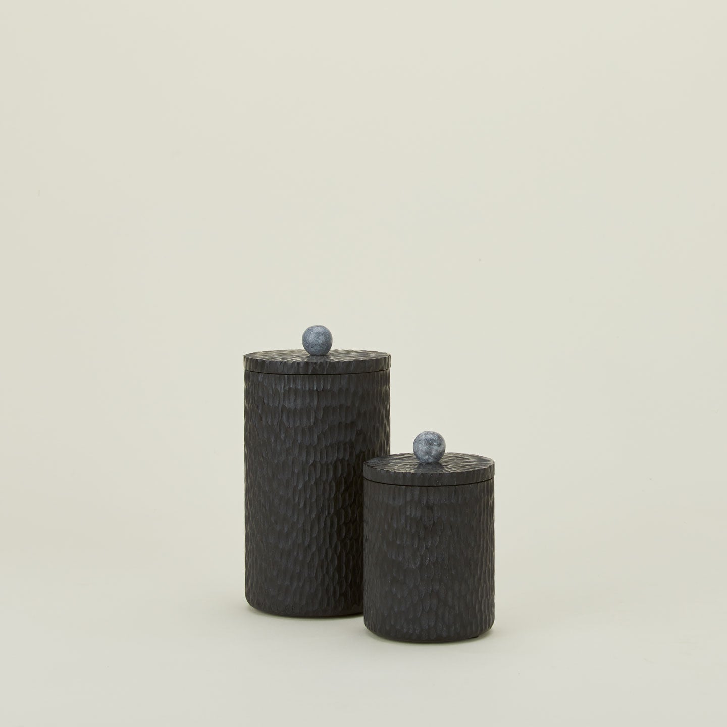 Camelia black wood lidded canister with marble knob in two sizes.