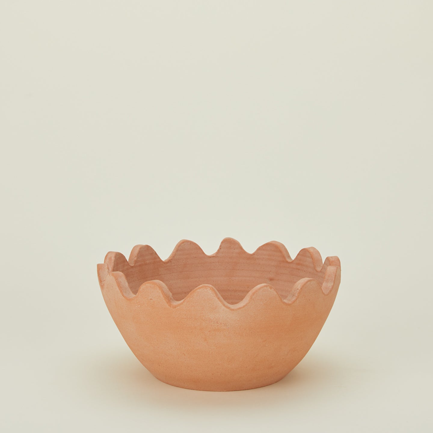 Ena terracotta bowl with ridged edges.