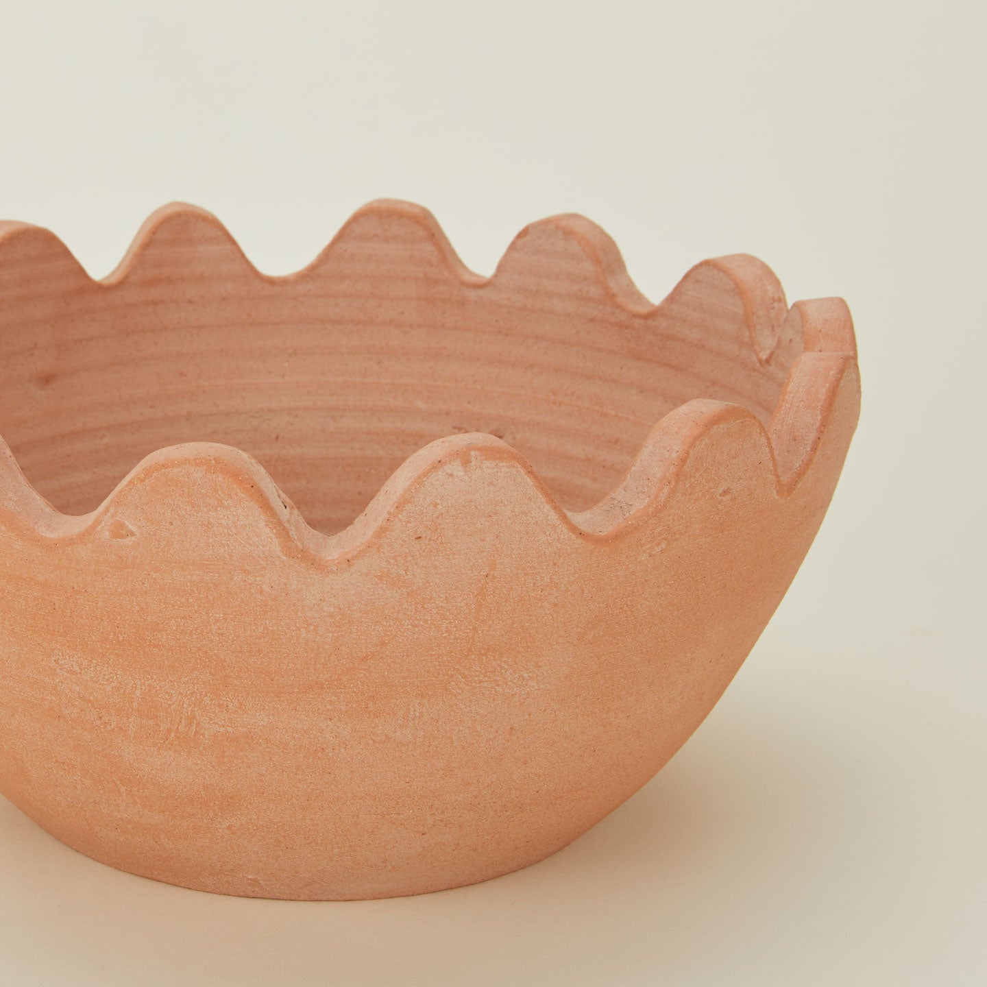 Close up of Ena terracotta bowl with ridged edges.