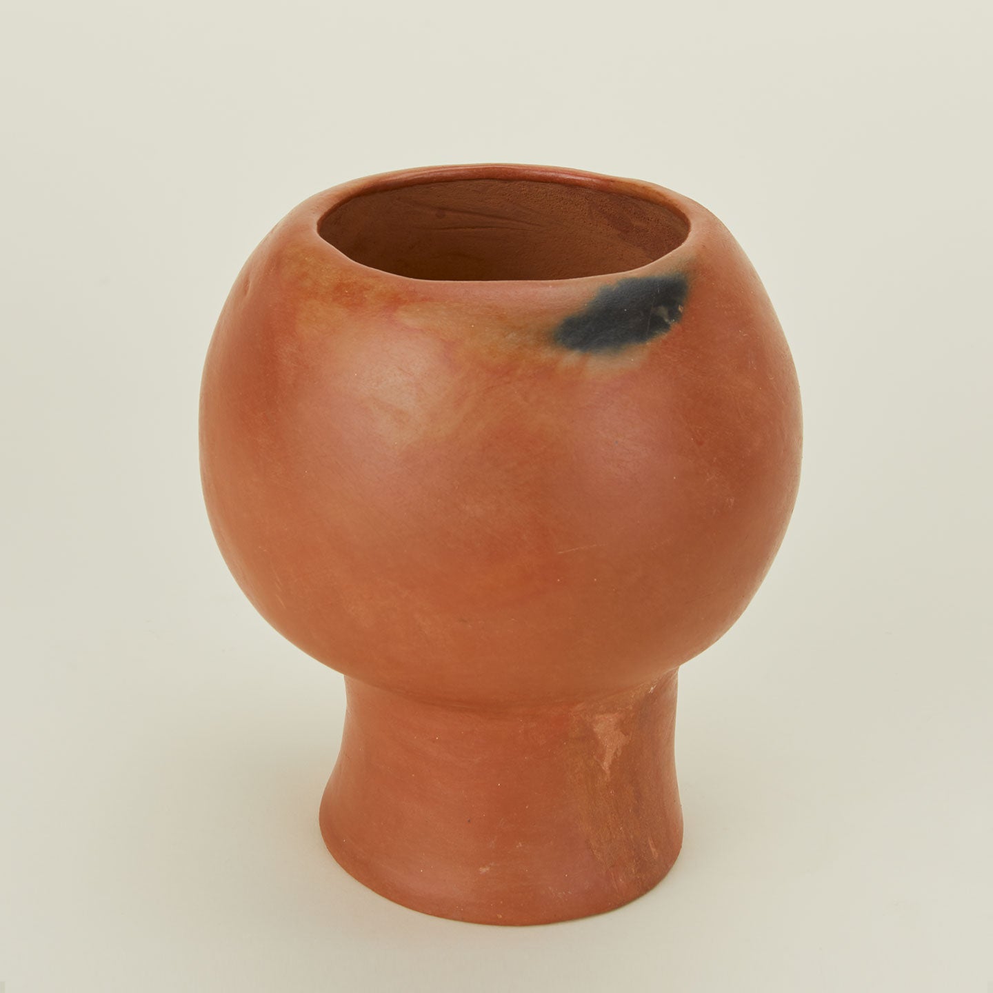 Close up of Trompo terracotta vase.