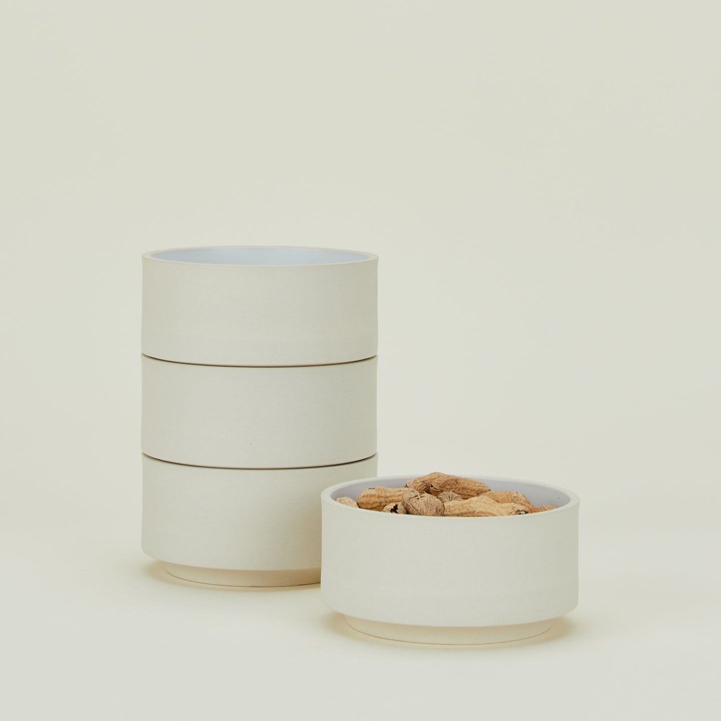 Four Modernist Cereal Bowls, filled with peanuts.