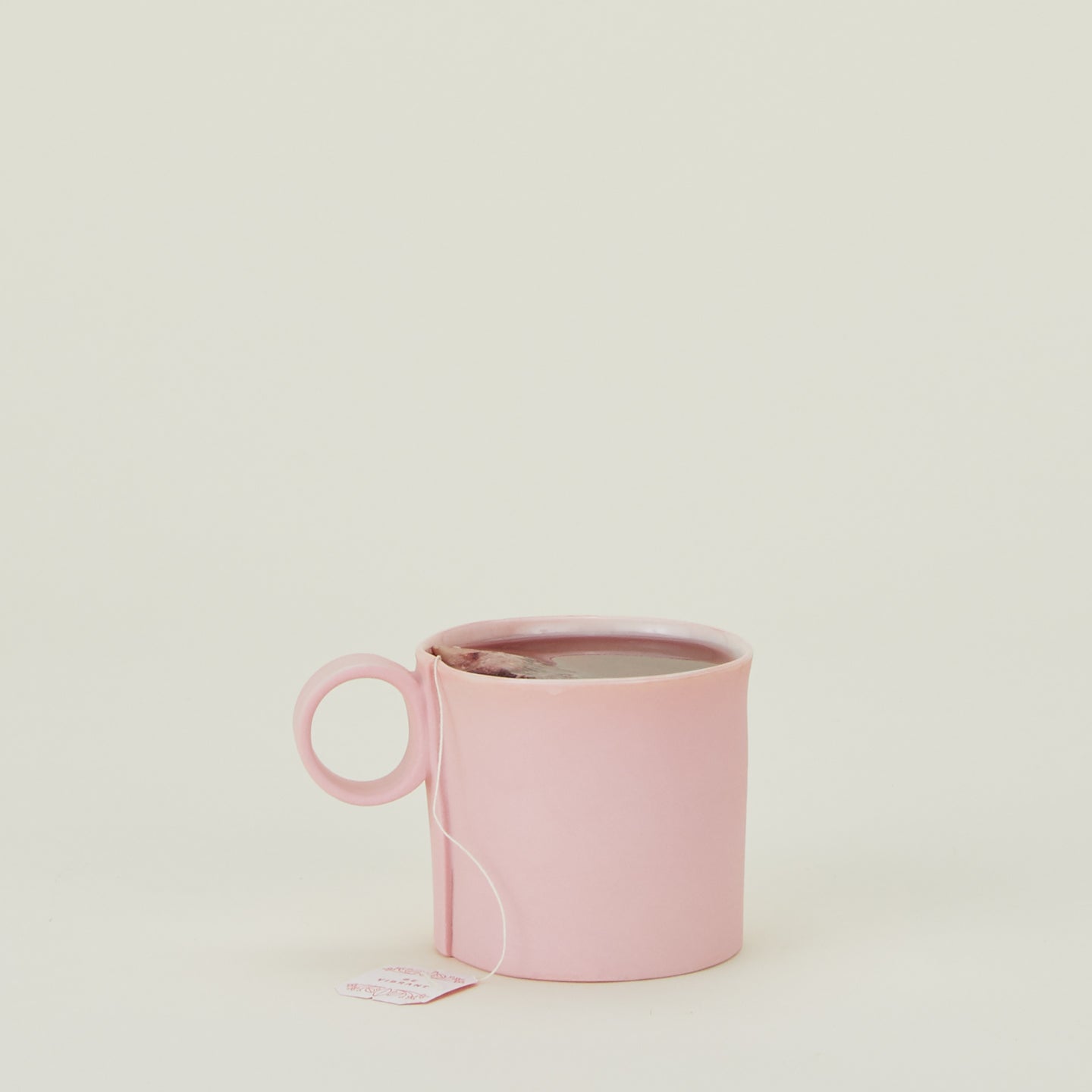 Loop Handled Mug in Blush, with tea.