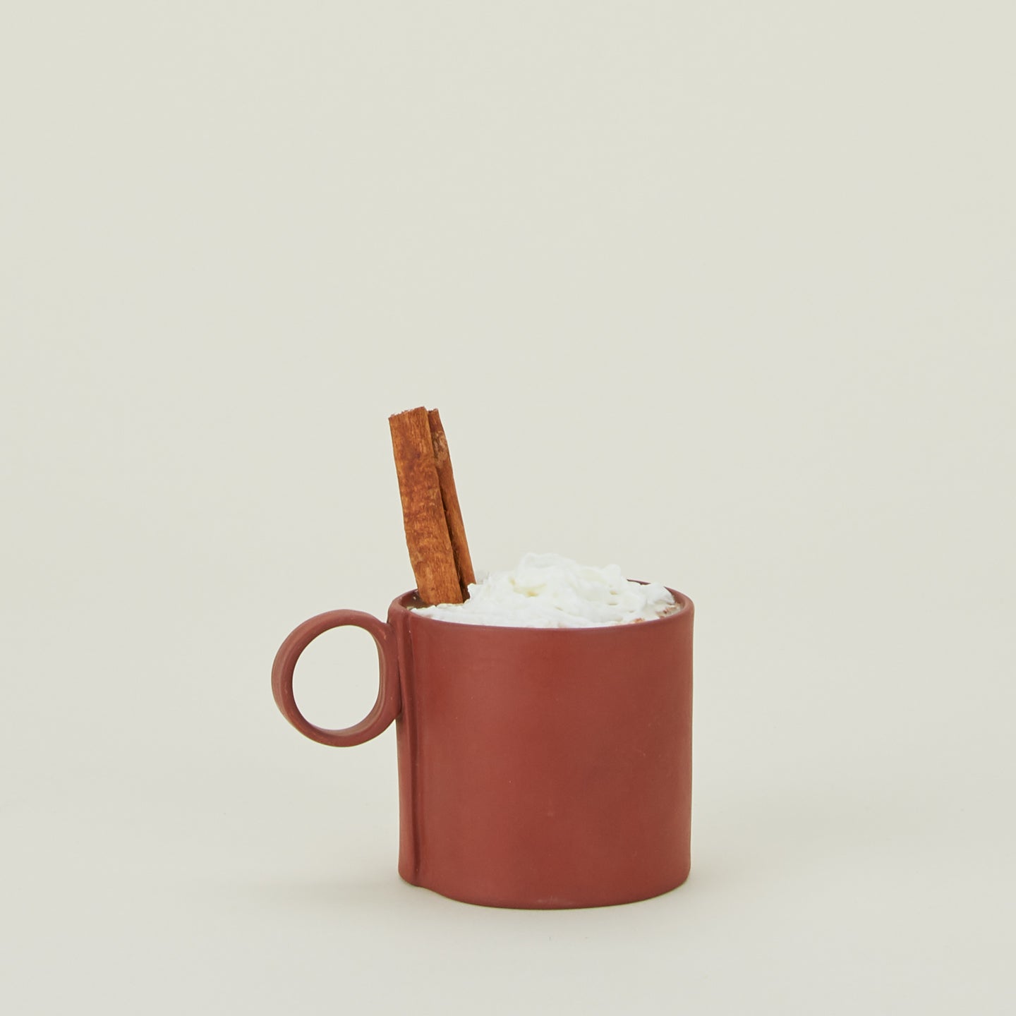 Loop Handled Mug in Terracotta, with whipped cream and cinnamon stick.