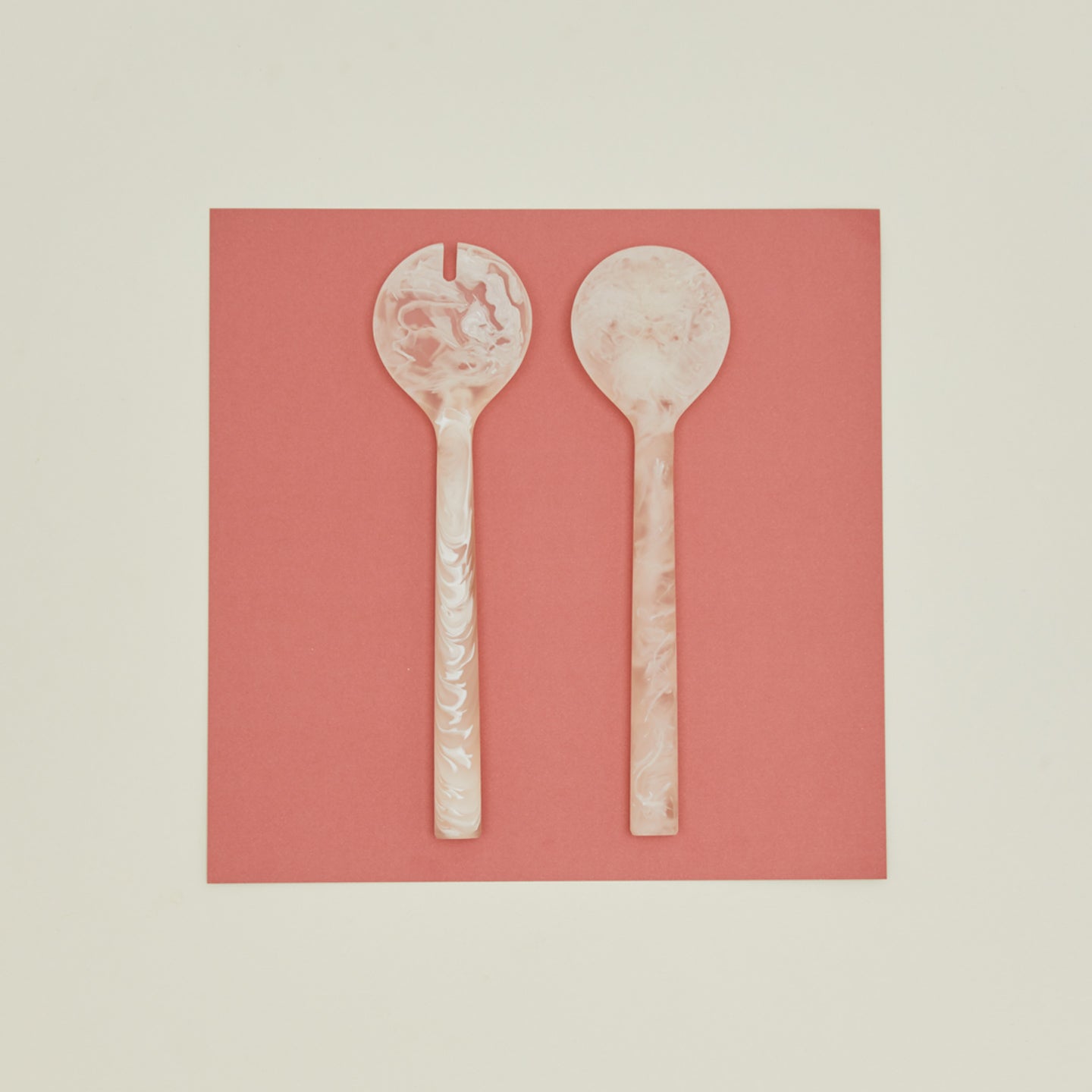 Flow resin salad servers on red paper