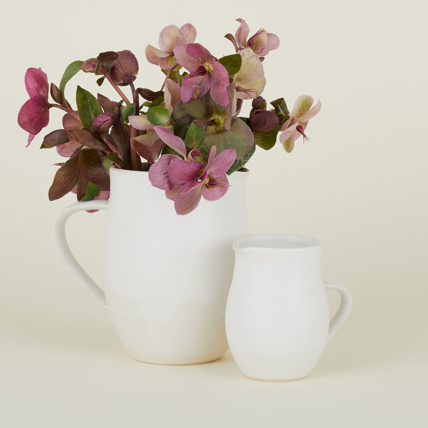 Stoneware Creamer and Stoneware Pitcher in Eggshell with flowers.