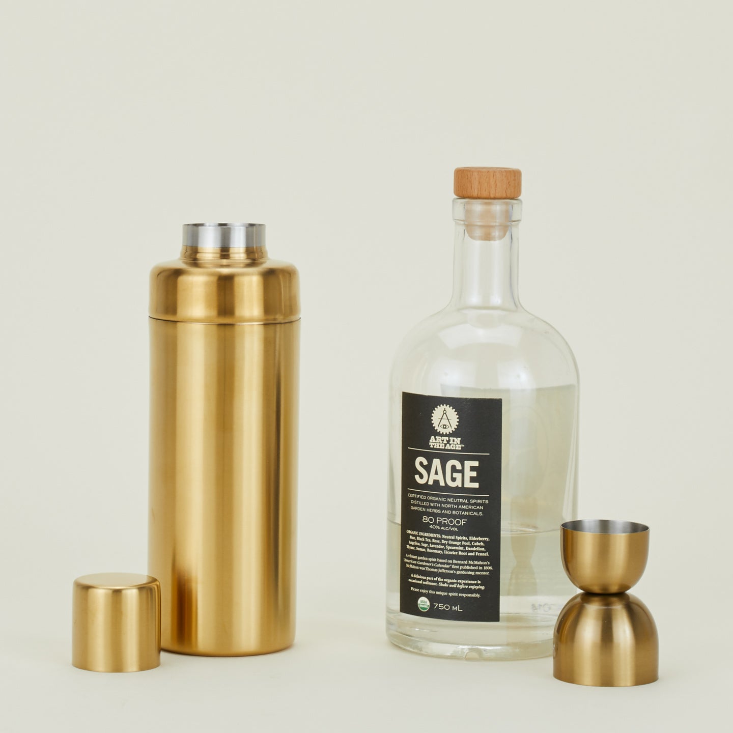 Simple Cocktail Shaker and Simple Jigger with bottle of spirits.