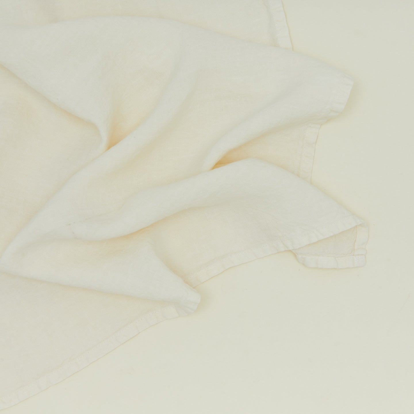 Detailed view of simple linen napkin in ivory