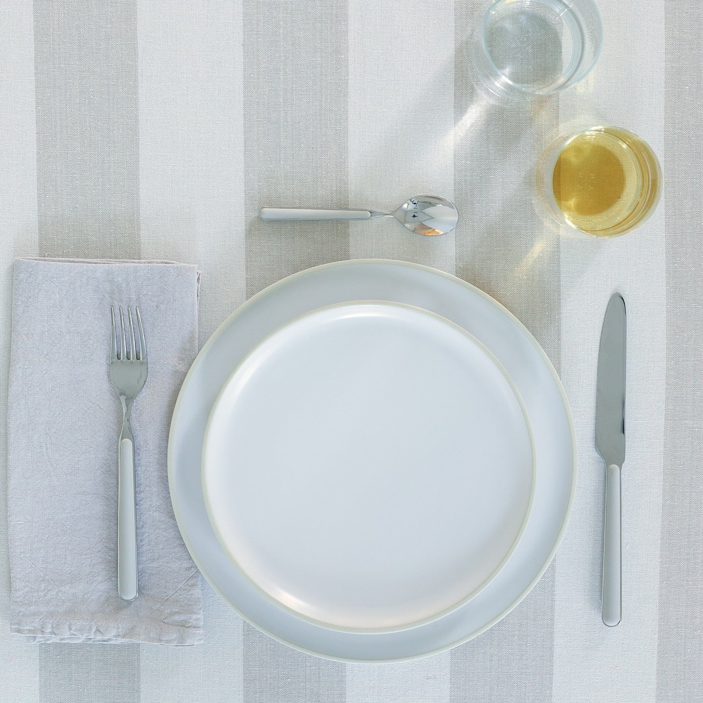 Placesetting with Simple Linen Napkin in Light Grey.