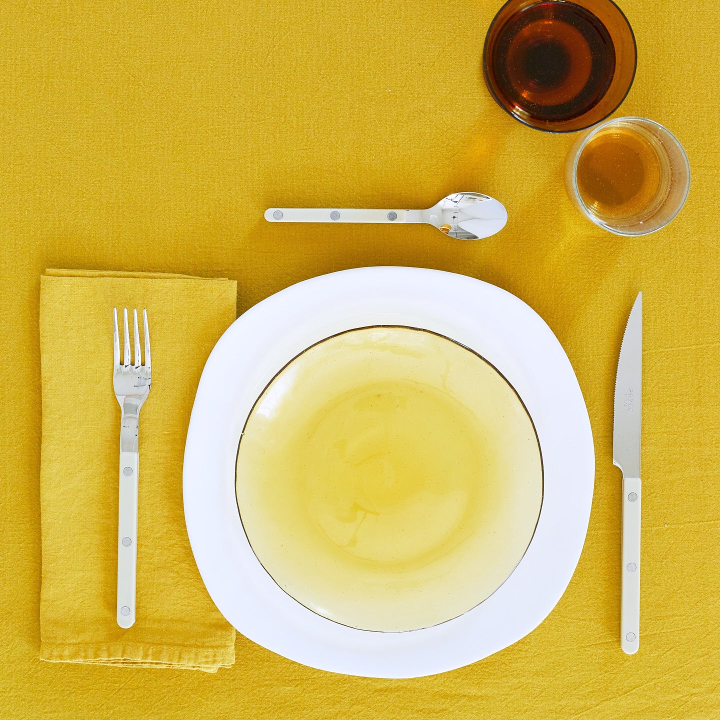 Placesetting with Simple Linen Napkin in Mustard.