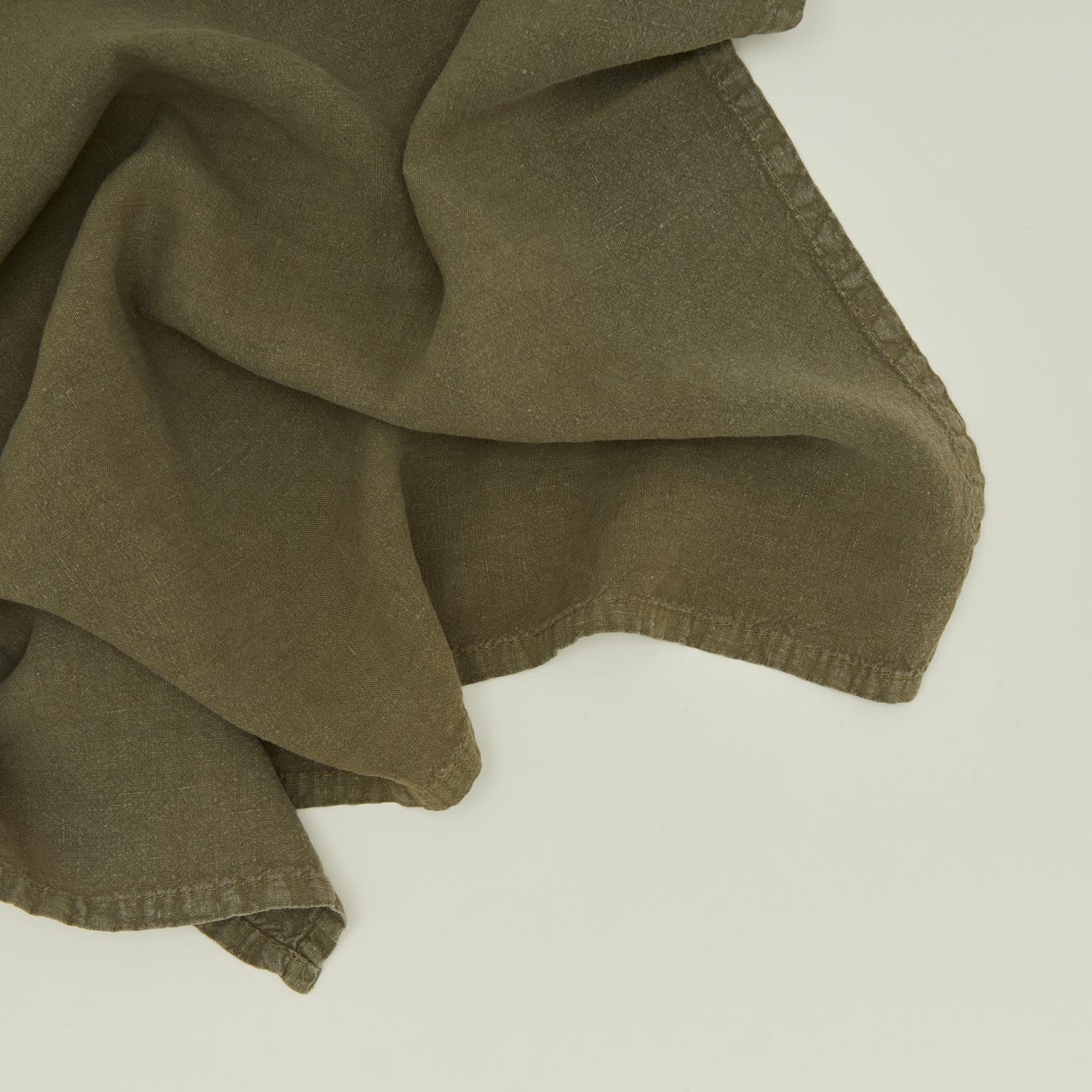 Detailed view of simple linen napkin in olive