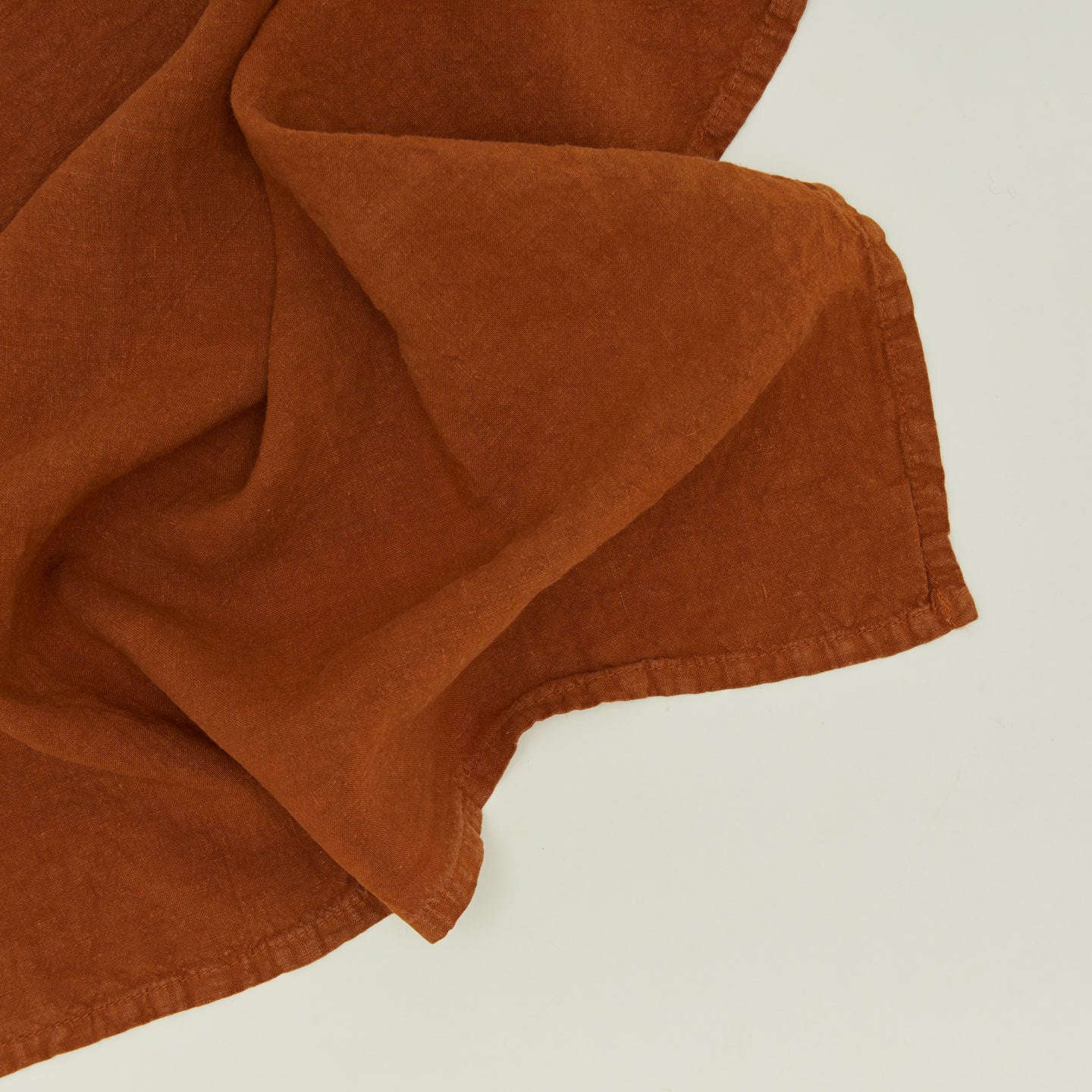 Detailed view of simple linen napkin in terracotta