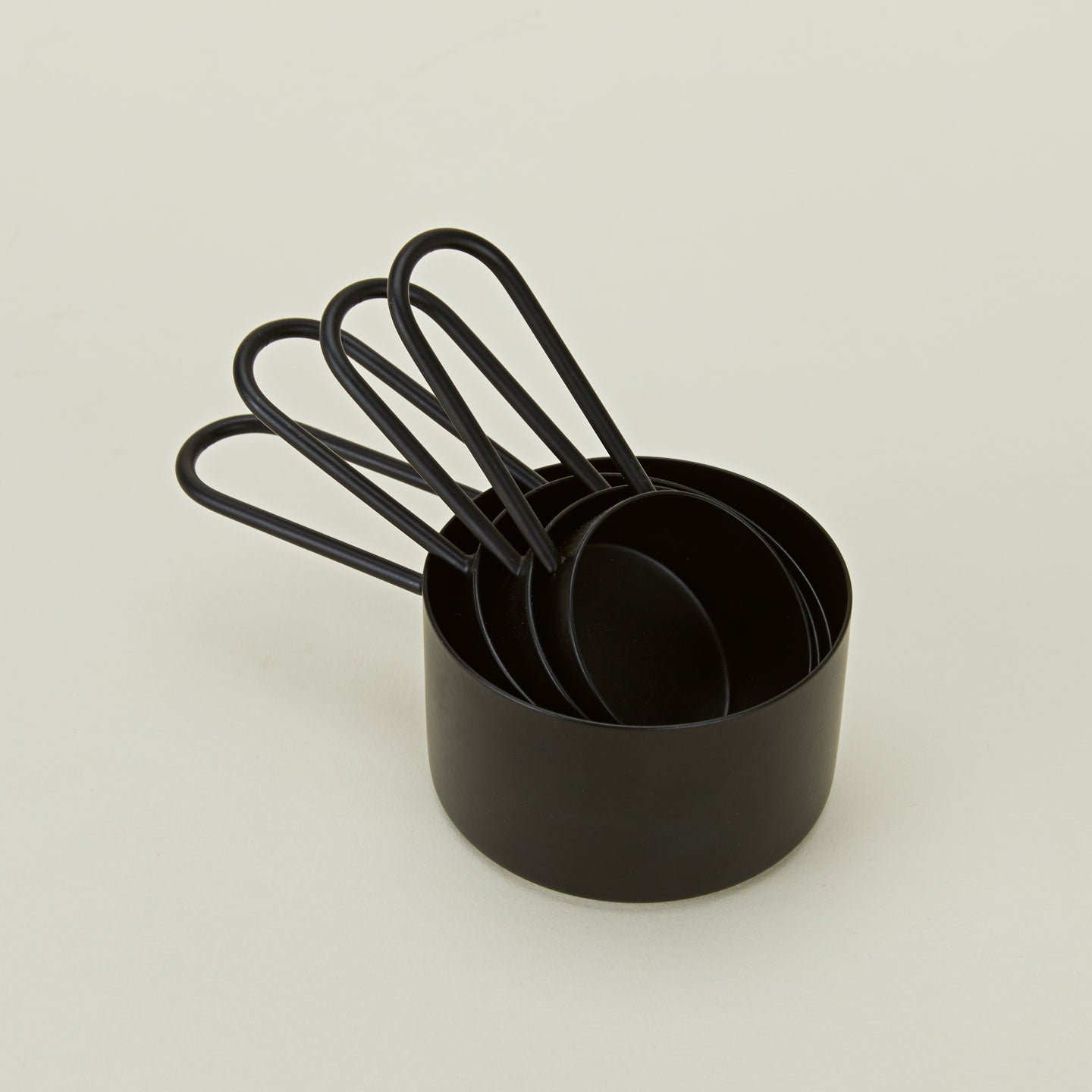 Simple measuring cups in black stacked