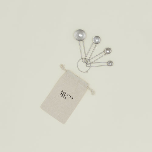 Simple measuring spoons in silver with linen storage bag