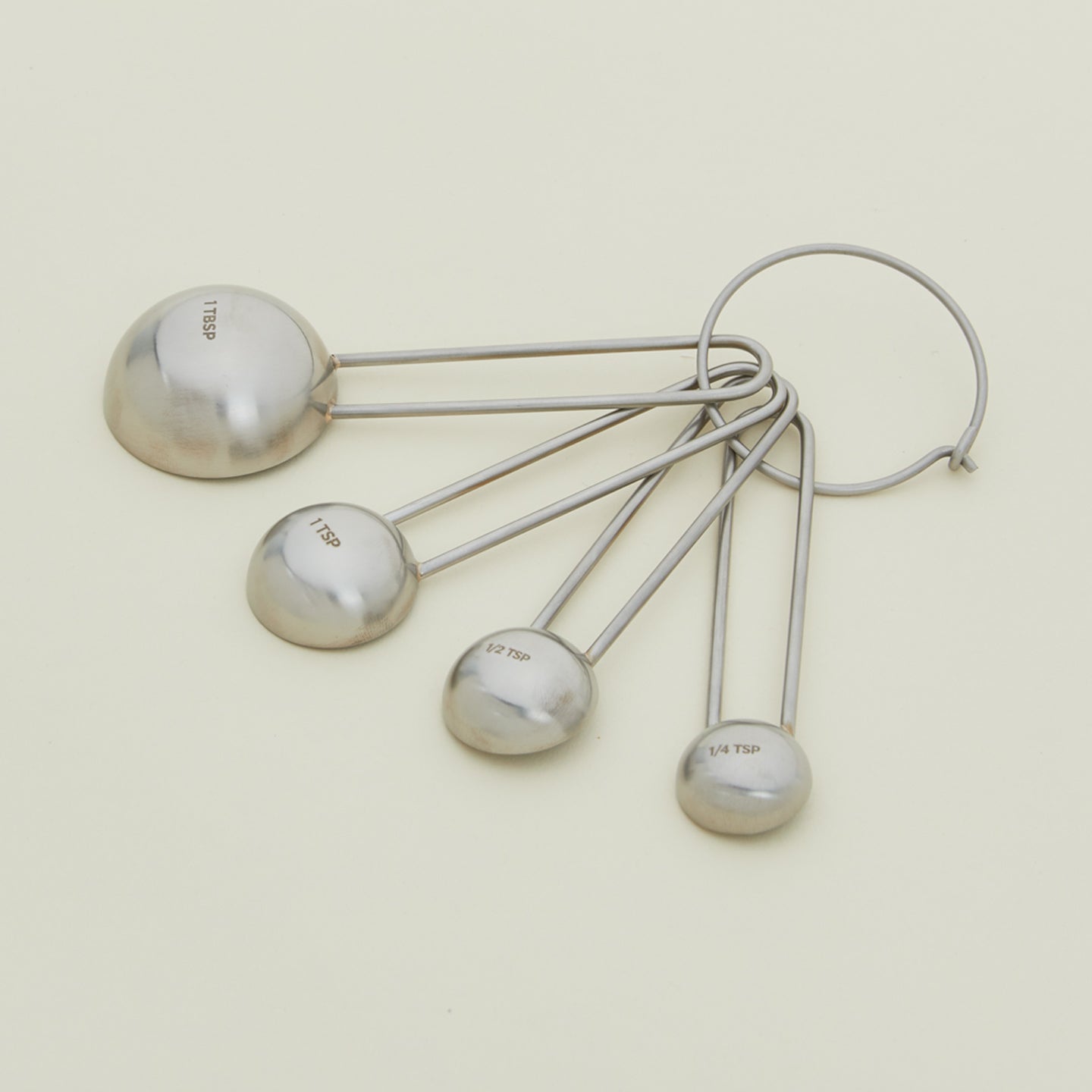 Detailed view of simple measuring spoons in silver