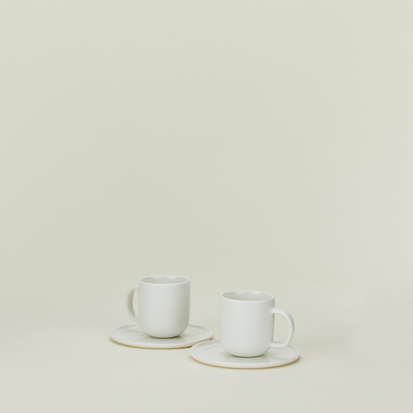 Simple porcelain espresso mugs with saucers in white