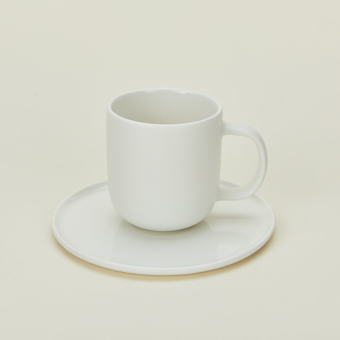 Simple porcelain espresso mug with saucer in white