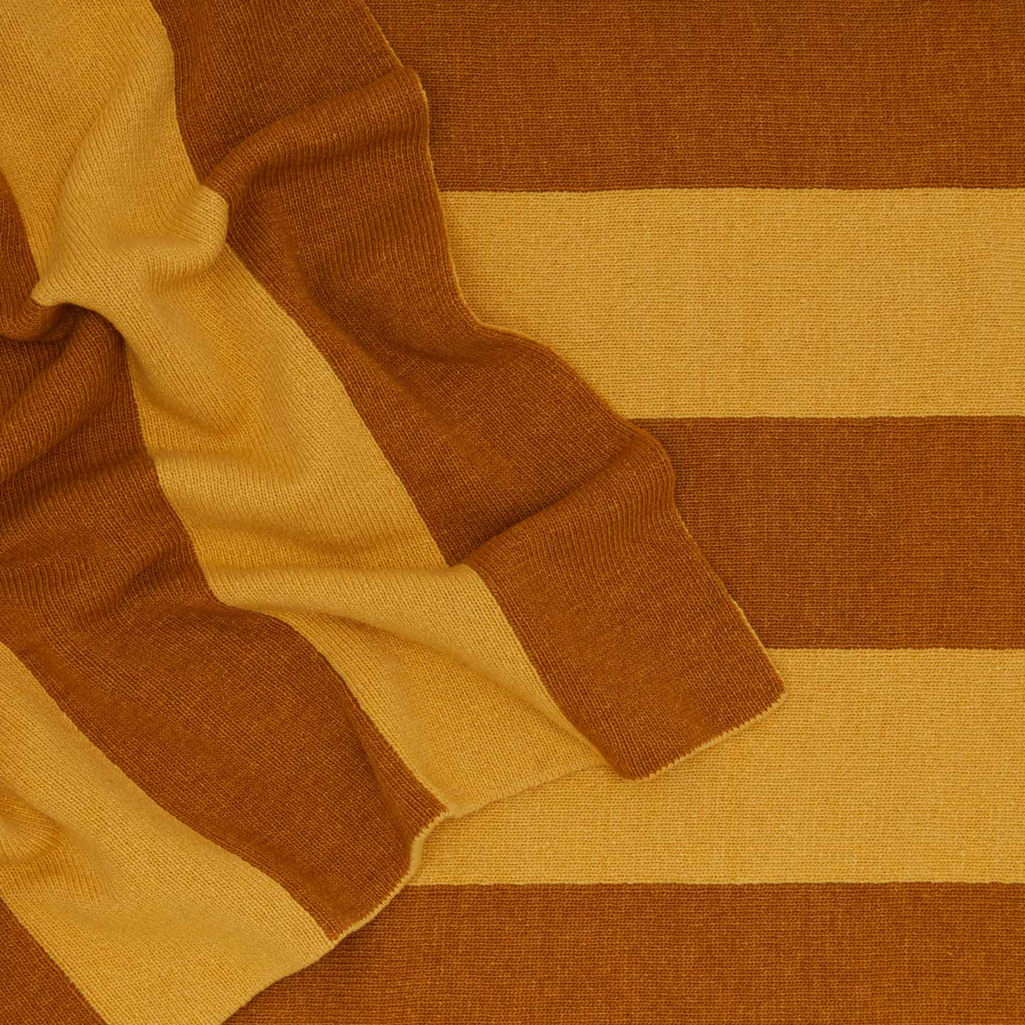 Striped throw in mustard and bronze close up 